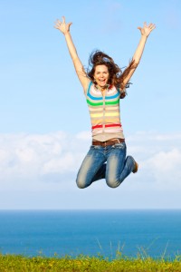 Girl jumping in air on beautiful day